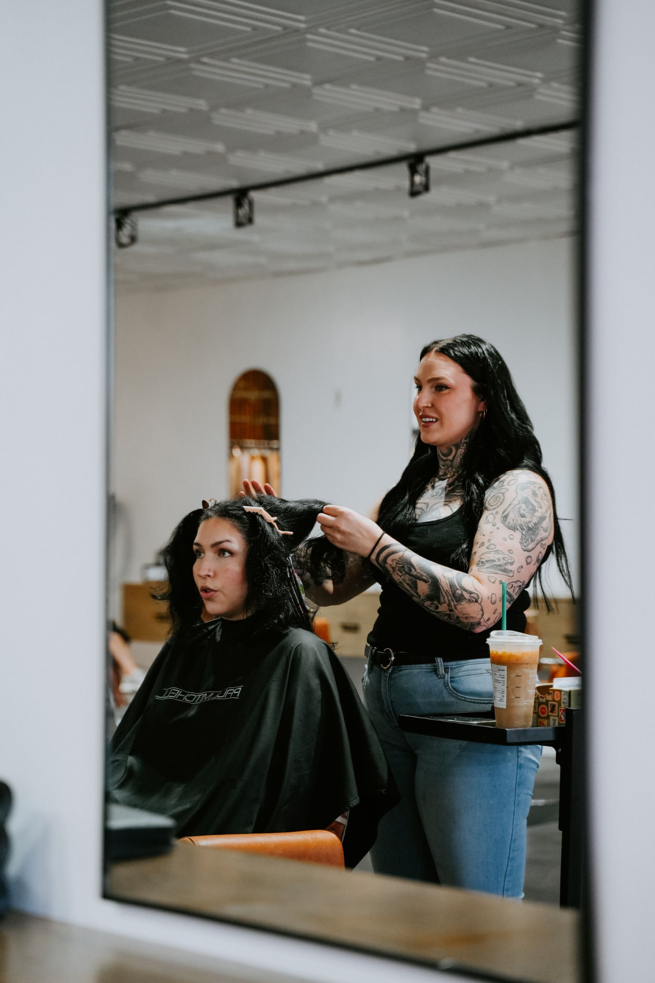 Blur. Salon stylist and client at the mirror in Oklahoma City