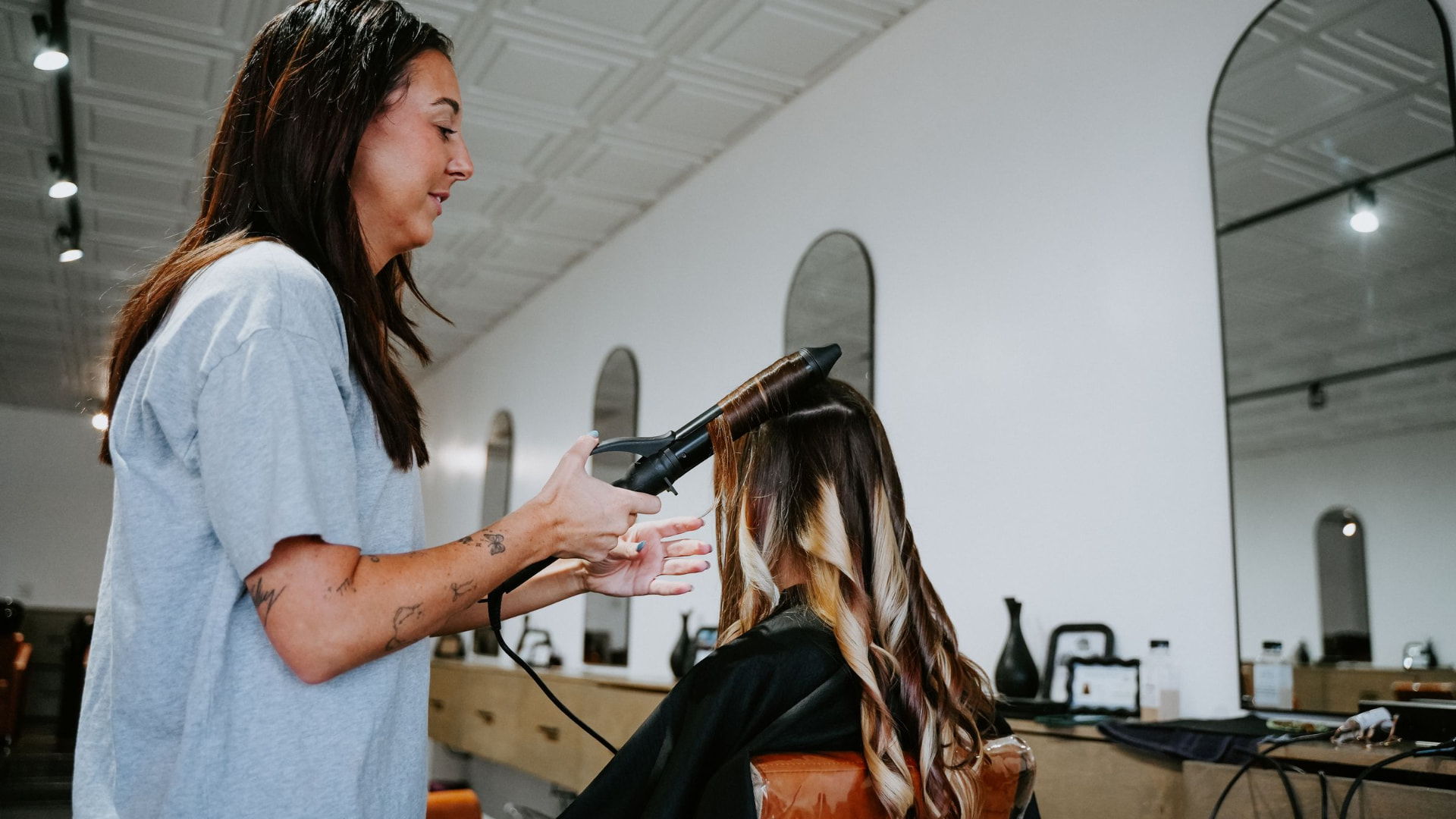 A Blur. Salon stylist finishing a client's hair in Oklahoma City